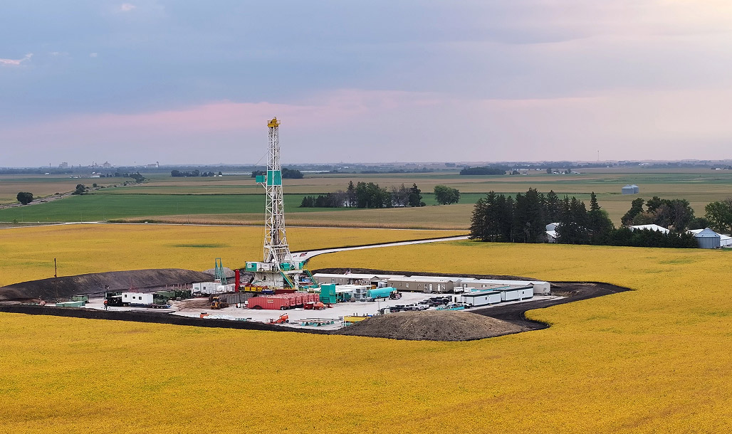 Drilling rig in bright yellow field