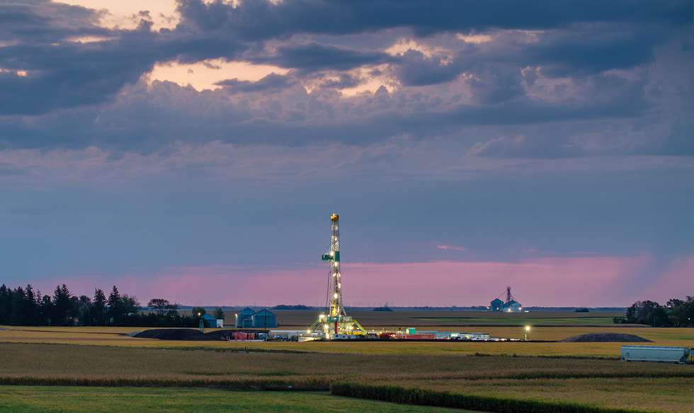 Drilling rig in field with purple sunset 12